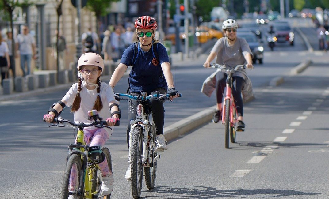 bicyclists, people, casual, helmet, woman, child, girl, running, bikes, track, lane, street, urban, sport, recreation, healthy, ecological